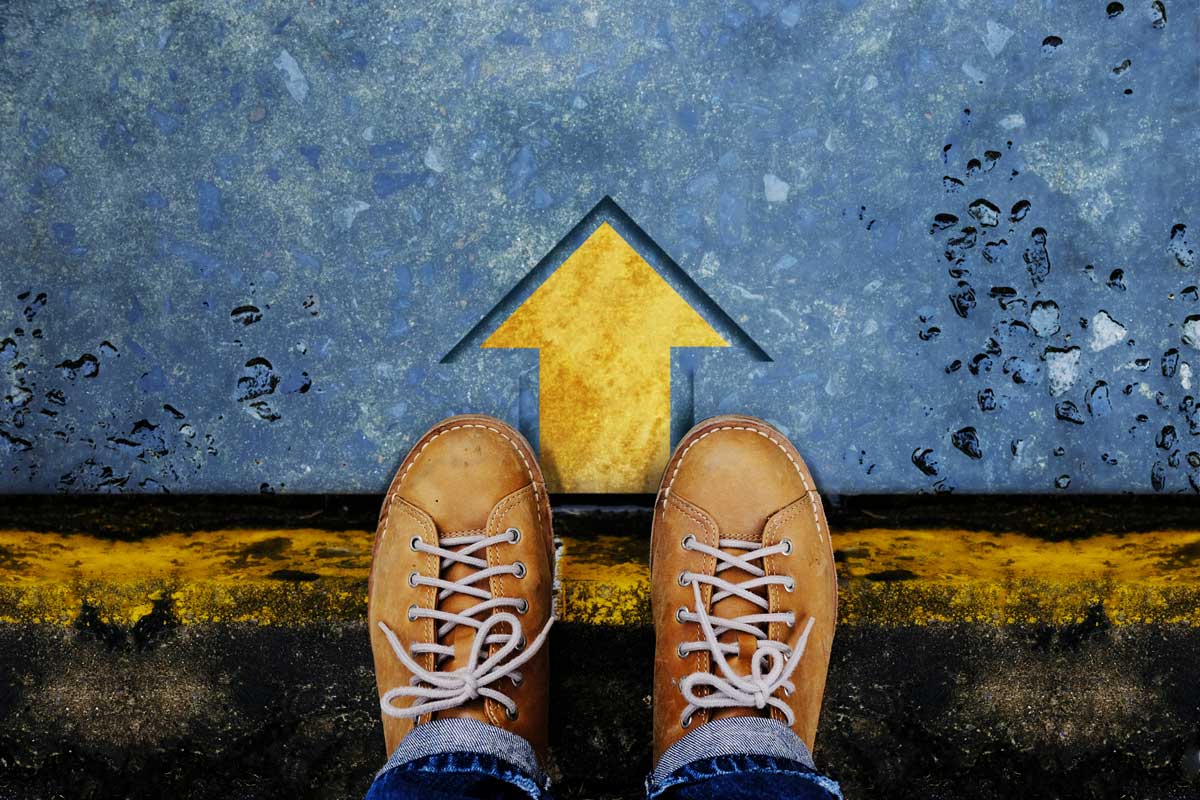 looking down from above on a person standing with an arrow in front of them